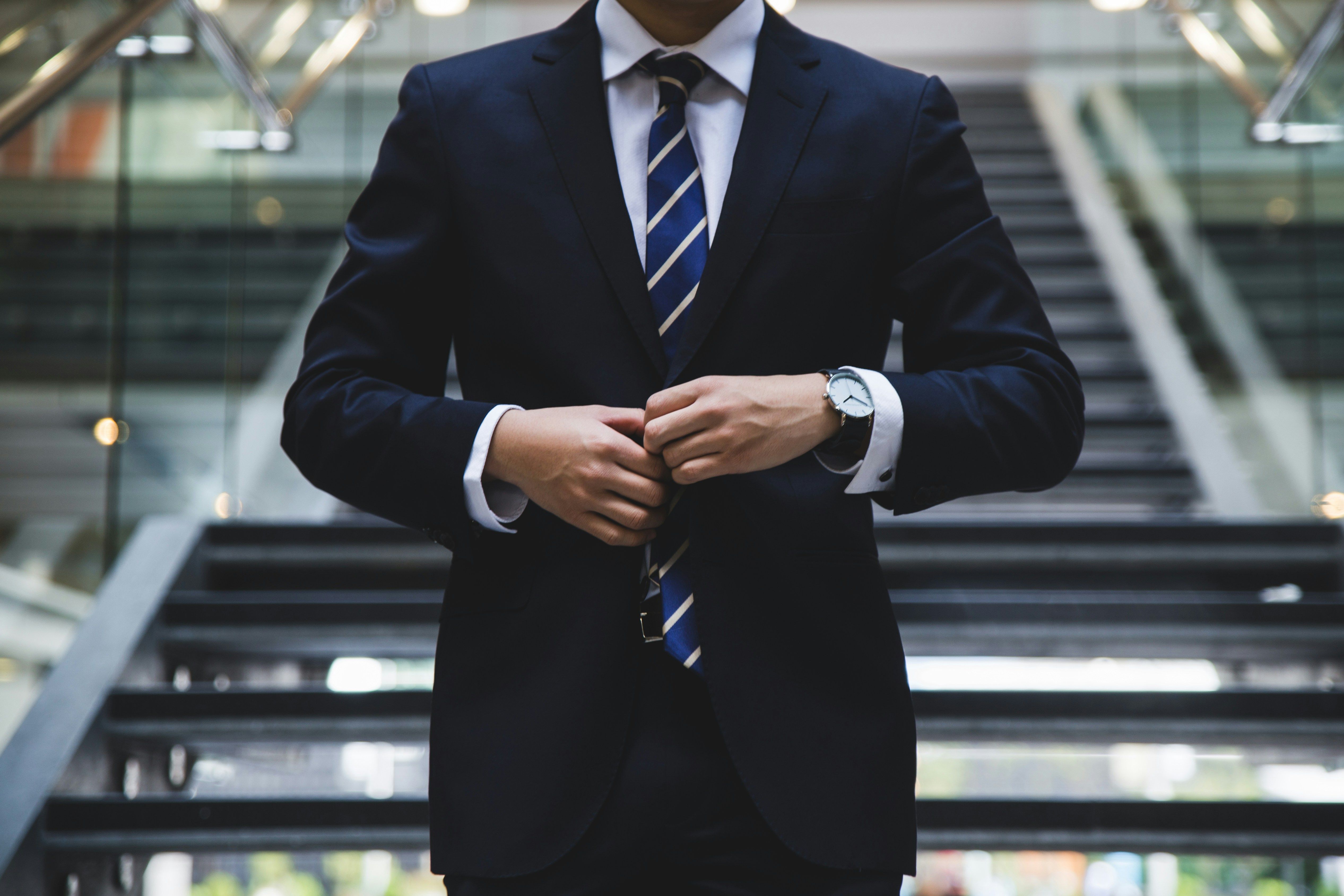 a man buttons his suit